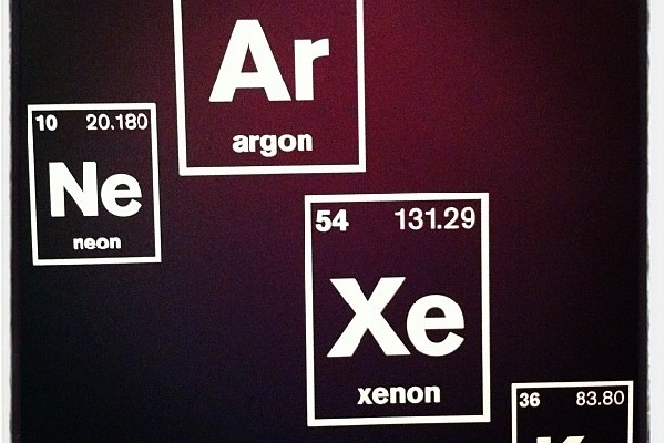 A board containing the elemental symbols of a few noble gases.
