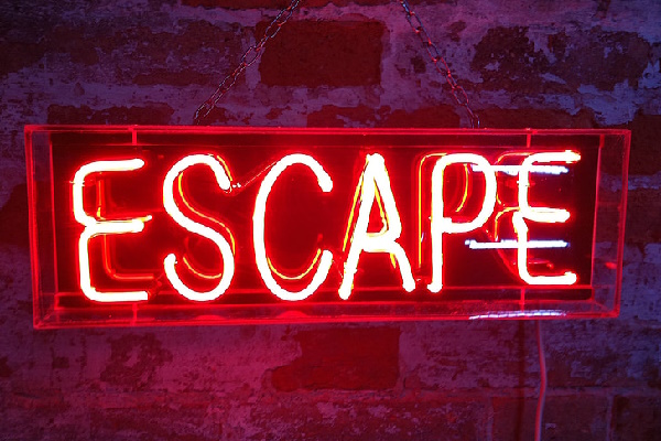 An image of a neon sign, reading 'ESCAPE'.